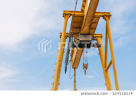 Overhead Crane beam machine with hoist hook head for lifting heavy duty, Construction machine arm in the sky. 124518214