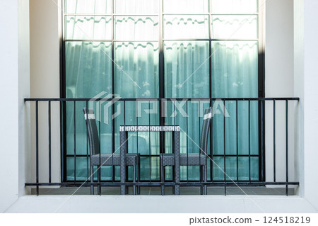 Hotel balcony area with chair and table set for smoke or relax outdoor 124518219