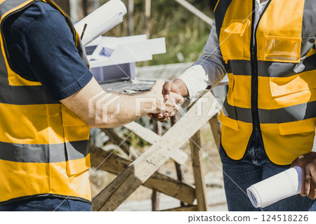Engineer male handshake with contractor negotiate with partner dealing construction project success 124518226