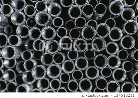 Stainless Steel threaded Pipes. SS threaded Pipes. Metal gas pipe stack pile in market shelf. 124518231