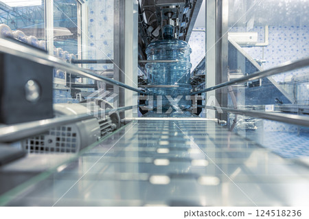 Drinking water production line on conveyor belt. PET Plastic water bottles in drink factory 124518236
