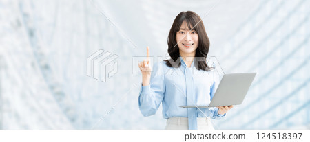 A smiling woman holding a computer and giving directions A smiling woman holding a computer and giving directions 124518397