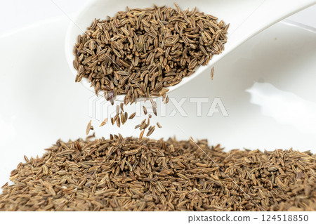 Whole cumin seeds Carum carvi L. in a spoon close-up Whole cumin seeds Carum carvi L. in a spoon close-up 124518850