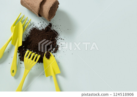 Various gardening hand green tools and soil on blue background. Spring gardening. Concept season work and hobby. Copy space. Top view. Various gardening hand green tools and soil on blue background. Spring gardening. Concept season work and hobby. Copy space. Top view. 124518906