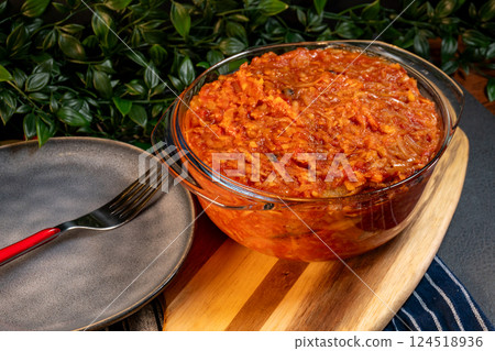 A stew of onions, vegetables and tomatoes. 124518936