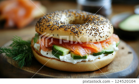 Bagel with Salmon, Avocado, and Cream on Wooden Board 124520104