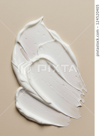 Cream swatch on beige surface in minimal skincare style 124520405