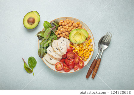 Healthy bowl with chicken breast, avocado, chickpeas, corn and tomatoes on grey background top view. Diet and healthy food concept Healthy bowl with chicken breast, avocado, chickpeas, corn and tomatoes on grey background top view. Diet and healthy food concept 124520638