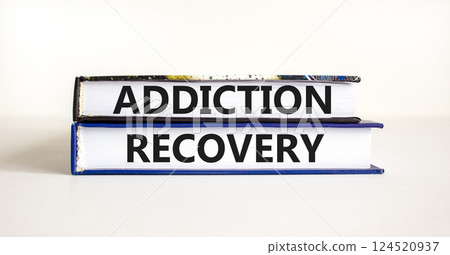 Addiction recovery symbol. Concept words Addiction recovery on beautiful books. Beautiful white table white background. Psychology addiction recovery concept. Copy space. Addiction recovery symbol. Concept words Addiction recovery on beautiful books. Beautiful white table white background. Psychology addiction recovery concept. Copy space. 124520937