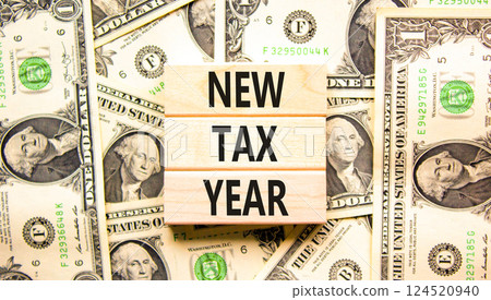 New tax year symbol. Concept words New tax year on beautiful wooden blocks. Dollar bills. Beautiful background from dollar bills. Business new tax year concept. Copy space. New tax year symbol. Concept words New tax year on beautiful wooden blocks. Dollar bills. Beautiful background from dollar bills. Business new tax year concept. Copy space. 124520940