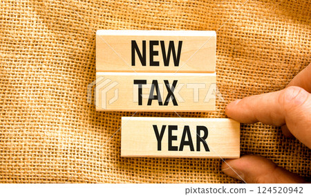 New tax year symbol. Concept words New tax year on beautiful wooden blocks. Beautiful canvas background. Businessman hand. Business new tax year concept. Copy space. 124520942