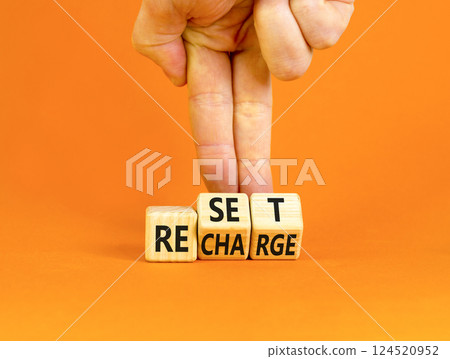 Reset and recharge symbol. Concept words Reset Recharge on beautiful wooden block. Beautiful orange table orange background. Businessman hand. Business reset and recharge concept. Copy space. 124520952