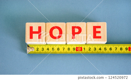 Hope symbol. Concept word Hope on beautiful wooden blocks. Beautiful yellow ruler. Beautiful blue table blue background. Business, lifestyle, support and hope concept. Copy space. Hope symbol. Concept word Hope on beautiful wooden blocks. Beautiful yellow ruler. Beautiful blue table blue background. Business, lifestyle, support and hope concept. Copy space. 124520972