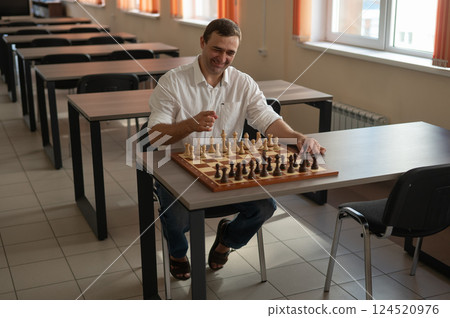 Caucasian man thinking about a chess move.  124520976