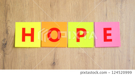 Hope symbol. Concept word Hope on beautiful colored paper. Beautiful wooden table wooden background. Business, lifestyle, support and hope concept. Copy space. 124520999