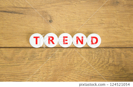 Trend and trending symbol. Concept word Trend on beautiful white circles. Beautiful wooden table wooden background. Business lifestyle trend and trending concept. Copy space. Trend and trending symbol. Concept word Trend on beautiful white circles. Beautiful wooden table wooden background. Business lifestyle trend and trending concept. Copy space. 124521054