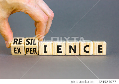 Resilience or experience symbol. Concept words Resilience Experience on beautiful wooden blocks. Beautiful grey background. Businessman hand. Business resilience or experience concept. Copy space 124521077