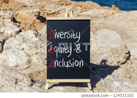 DEI diversity equity and inclusion symbol. Concept words DEI diversity equity and inclusion on blackboard. Beautiful stone background. Business DEI diversity equity and inclusion concept. Copy space. 124521101