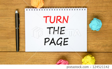 Turn the page symbol. Concept words Turn the page on beautiful white note. Black pen. Colored paper. Beautiful wooden background. Business motivational lifestyle turn the page concept. Copy space. 124521142