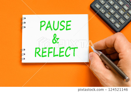 Pause and reflect symbol. Concept words Pause and reflect on beautiful white note. Beautiful orange background. Businessman hand. Business motivational lifestyle pause and reflect concept. Copy space. Pause and reflect symbol. Concept words Pause and reflect on beautiful white note. Beautiful orange background. Businessman hand. Business motivational lifestyle pause and reflect concept. Copy space. 124521146