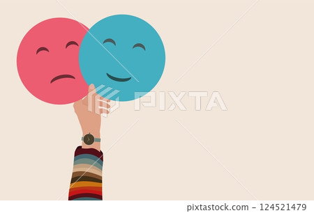 Hand holding 2 double emoji Head one smiling and the other sad.Metaphor bipolar disorder mind mental.Mood disorder Concept.Psychology.Mental health.Split personality.Banner copy space 124521479