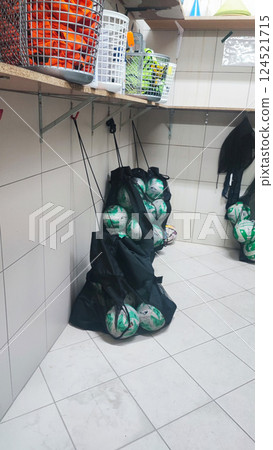 Many different sports equipment in room with beige walls. Concept of youth sports, soccer schools for children. 124521715