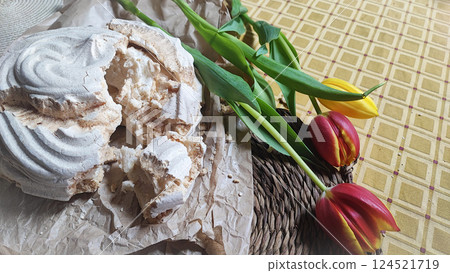 Huge meringue on a decorated rustic table with a backdrop of flowers. Traditional dessert of Aveiro, Portugal, Costa Nova 124521719