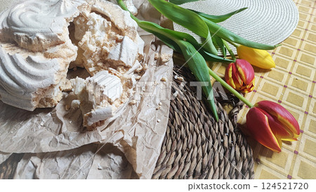 Huge meringue on a decorated rustic table with a backdrop of flowers. Traditional dessert of Aveiro, Portugal, Costa Nova 124521720