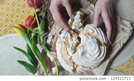 Huge meringue on a decorated rustic table with a backdrop of flowers. Traditional dessert of Aveiro, Portugal, Costa Nova 124521721