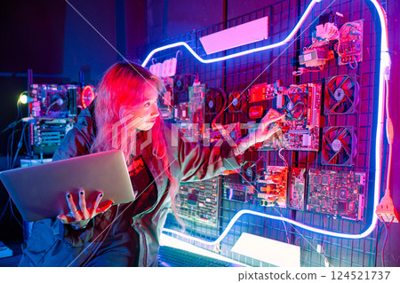 Cyber security. Software engineer holding laptop computer at data center checking hardware, Hacker woman service in server room, check circuit board with many small components Cyber security. Software engineer holding laptop computer at data center checking hardware, Hacker woman service in server room, check circuit board with many small components 124521737