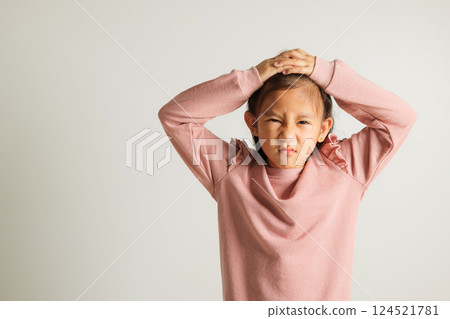 Asian portrait young kid girl standing angry and mad raising fist frustrated and furious while shouting with anger isolated, studio shot on white background, kindergarten child not happy Asian portrait young kid girl standing angry and mad raising fist frustrated and furious while shouting with anger isolated, studio shot on white background, kindergarten child not happy 124521781