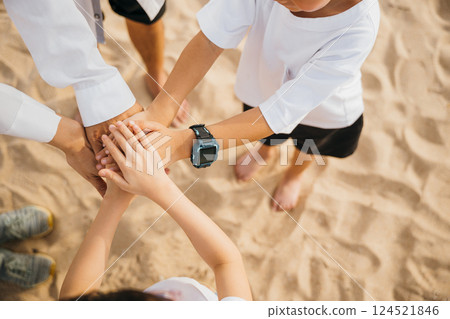 Beach teamwork for family success. Hands stack in unity representing achievement. Parents and children connect in nature illustrating community motivation and togetherness Beach teamwork for family success. Hands stack in unity representing achievement. Parents and children connect in nature illustrating community motivation and togetherness 124521846