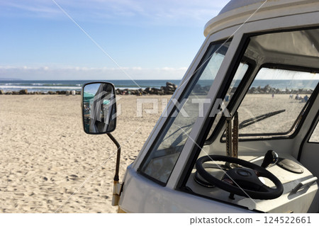 Window With Mirror Of Orange Camper Van Parked In The Seashore, Yellow Sand And Water, Ocean Line On Background, Travel Destination, Summer And Vacation. Horizontal. 124522661