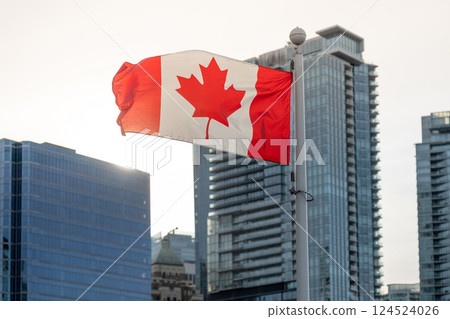 Canada Flag and Vancouver City skyscrapers skyline in the background with sunlight. Concept of canadian urban city life. 124524026