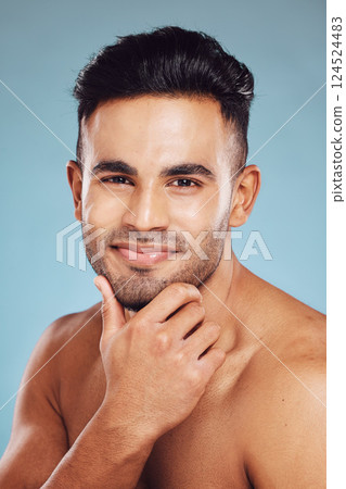 Skincare, beauty and a portrait of man, topless touching beard with healthy skin and natural facial glow and smile on face in India. Male body care, health and model in studio with blue background. 124524483
