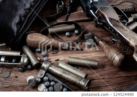 16 gauge break action smooth bored shotgun with brass cases and accessories for cartridge reloading. 124524490
