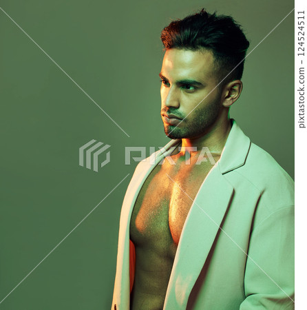 Neon, beauty and fashion with light and man with mockup for glowing, sexy and wellness. Creative, art and designer with young model in green background in studio for gradient, cosmetics and color Neon, beauty and fashion with light and man with mockup for glowing, sexy and wellness. Creative, art and designer with young model in green background in studio for gradient, cosmetics and color 124524511