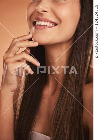 Skincare, hair and beauty with woman in studio for grooming, hygiene and keratin treatment on orange background. Face closeup, wellness and girl model smile, relax and happy with brazilian hair care 124524519