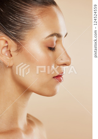 Face, beauty and skincare with a model woman profile posing in studio on a beige background for wellness. Cosmetics, wellness and natural with an attractive young female posing to promote a product Face, beauty and skincare with a model woman profile posing in studio on a beige background for wellness. Cosmetics, wellness and natural with an attractive young female posing to promote a product 124524559