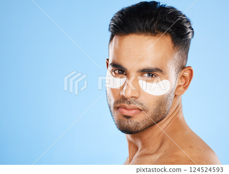 Skincare, eyes patch and man portrait of beauty product, body cosmetics and wellness, facial treatment and aesthetic health on studio blue background. Arab guy face portrait, hydration and self care Skincare, eyes patch and man portrait of beauty product, body cosmetics and wellness, facial treatment and aesthetic health on studio blue background. Arab guy face portrait, hydration and self care 124524593