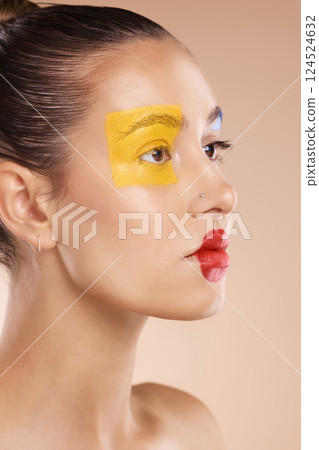 Beauty, woman and paint on face, makeup or creative art on studio background. Clown, fashion cosmetics or unique self expression, thinking female model from Canada with red lips and yellow eyeshadow. Beauty, woman and paint on face, makeup or creative art on studio background. Clown, fashion cosmetics or unique self expression, thinking female model from Canada with red lips and yellow eyeshadow. 124524632