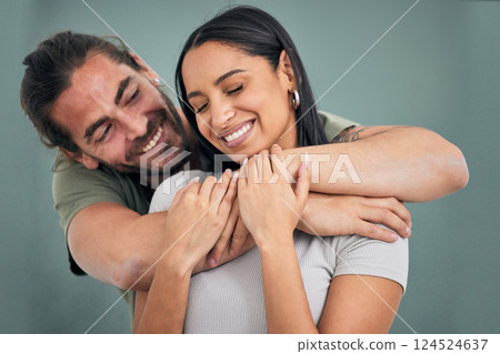 Love, hug and support of a couple in a home with smile, care and affection. Trust, help and embrace of marriage or young interracial people, comforting partner together in their house with happiness 124524637
