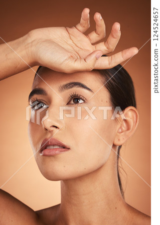 Hand, face and beauty with a model woman in studio on a beige background to promote natural care. Skincare, cosmetics and treatment with an attractive young female posing for a skin product Hand, face and beauty with a model woman in studio on a beige background to promote natural care. Skincare, cosmetics and treatment with an attractive young female posing for a skin product 124524657