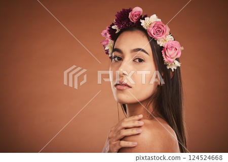 Makeup, beauty and woman with floral crown on head to model for cosmetics, beauty products and fashion. Creative, hair and artistic portrait of girl with flower headband on brown background studio 124524668