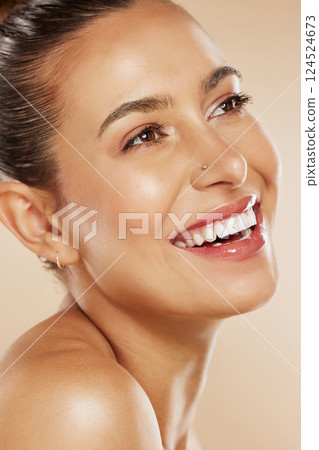 Face, beauty and skincare with a model woman in studio on a beige background with a happy smile or idea for wellness. Luxury, cosmetics and natural with a young female posing to promote a product Face, beauty and skincare with a model woman in studio on a beige background with a happy smile or idea for wellness. Luxury, cosmetics and natural with a young female posing to promote a product 124524673