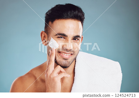 Cream, skincare and portrait of the face of a man with moisturizer after a shower against a blue mockup studio background. Sunscreen, wellness and smile of a young model with facial creme for skin Cream, skincare and portrait of the face of a man with moisturizer after a shower against a blue mockup studio background. Sunscreen, wellness and smile of a young model with facial creme for skin 124524713