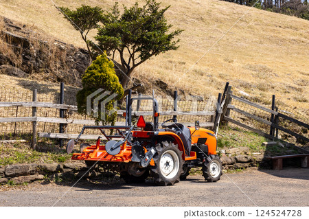 A red tractor in a park 124524728