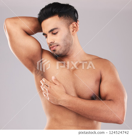 Beauty, healthy body and strong man in studio, flex muscles, arm and biceps for strength. Wellness, fitness and young male bodybuilder on gray background for body care, workout and exercise in studio 124524742