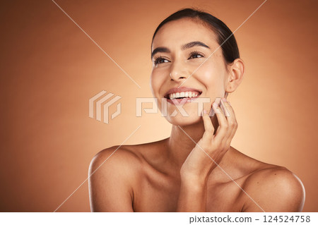 Thinking, beauty and skincare of hispanic woman against a brown studio background. Clean, smooth face skin of a happy woman after cosmetology and dermatology treatment for health and wellness 124524758