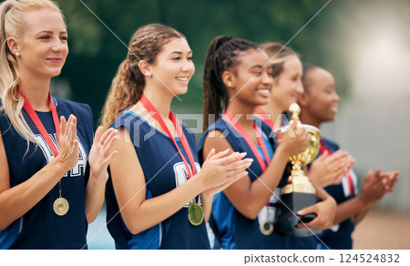 Netball team, clapping and medal, trophy and winner in sports competition, tournament and game outdoor. Teamwork, support and gold award for achievement, winner and celebration at sport event outdoor Netball team, clapping and medal, trophy and winner in sports competition, tournament and game outdoor. Teamwork, support and gold award for achievement, winner and celebration at sport event outdoor 124524832
